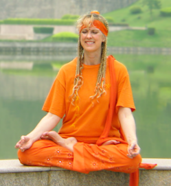 Yogini Kaliji in meditation in China, in front of lake